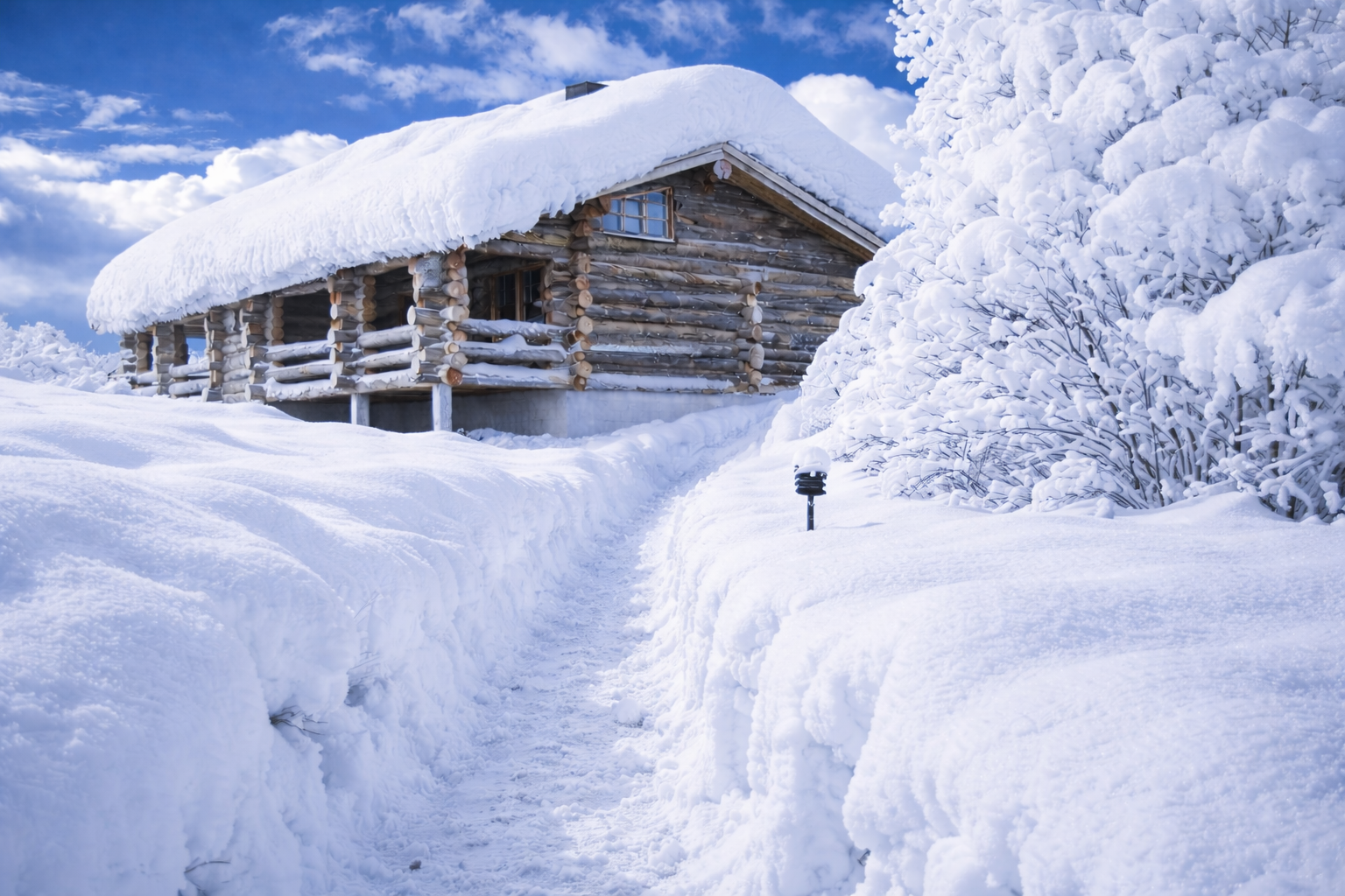 Log cabin in deep winter snow
