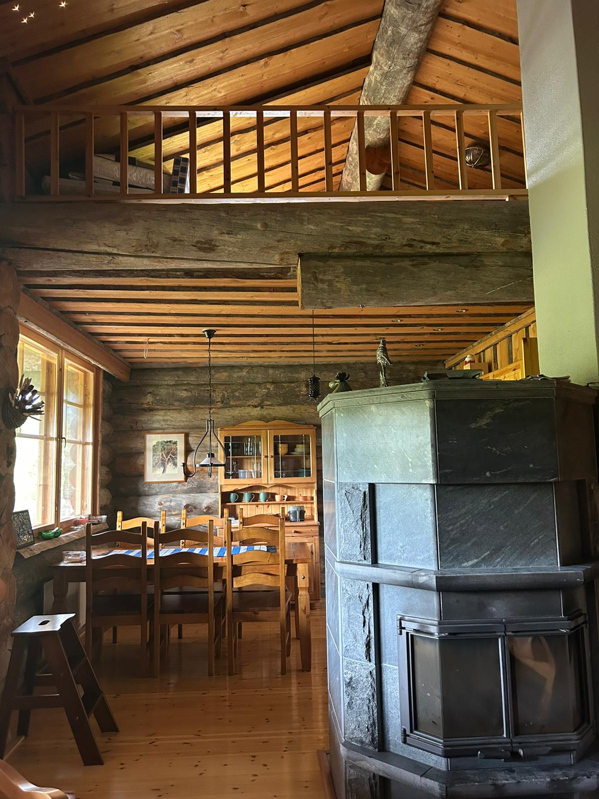Soapstone fireplace, dining area, loft railing above